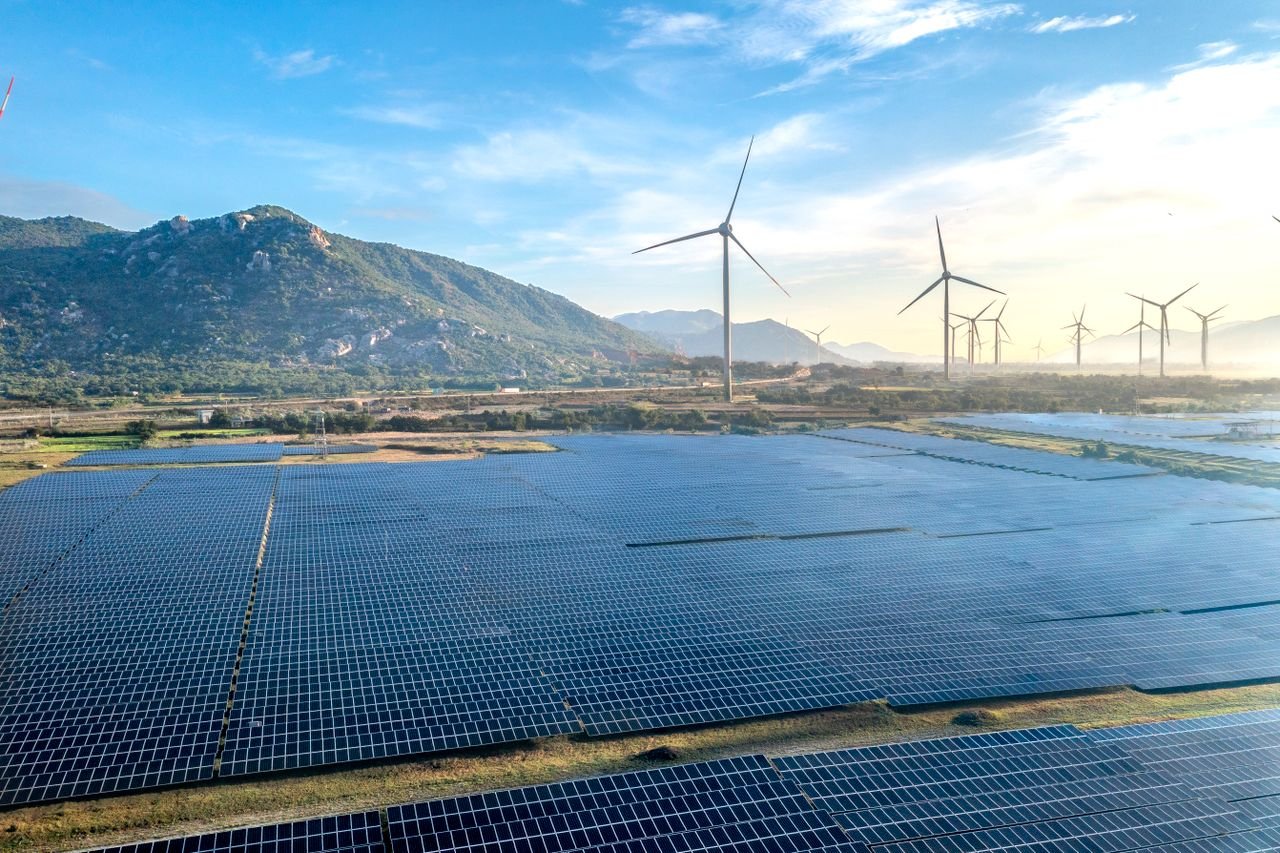 Mastering the First Impression: Your intriguing post title goes here Aerial view of a solar and wind energy farm set against Vietnam's scenic landscape.
