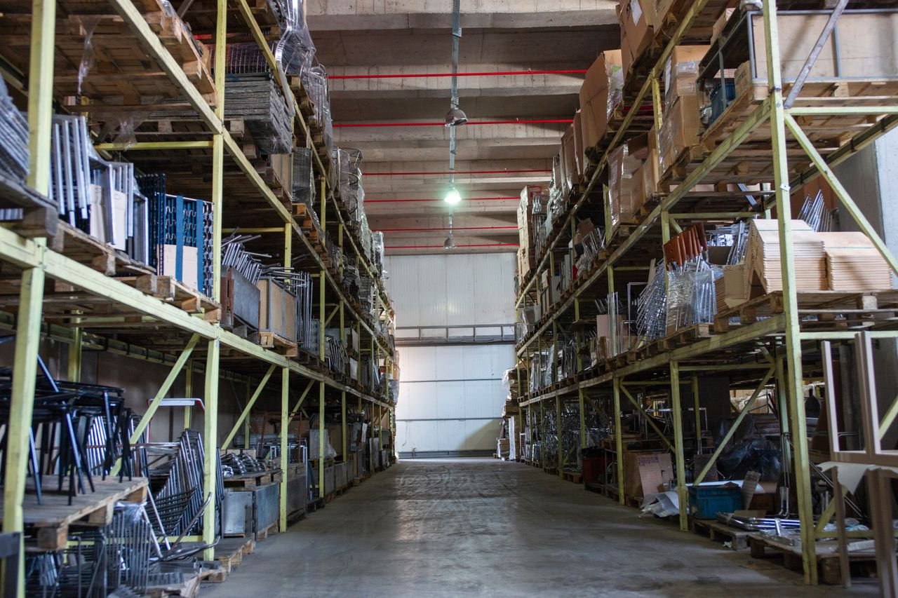 The Art of Drawing Readers In: Your attractive post title goes here Wide aisle in a spacious warehouse filled with industrial metal shelving units.